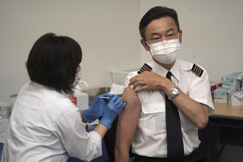 The Latest: Japanese airline starts crew vaccination drive