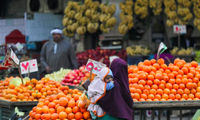 A woman holding her baby shops at a vegetable market amid the coronavirus disease (COVID-19) pandemic in Cairo, Egypt February 25, 2021. REUTERS/Mohamed Abd El Ghany