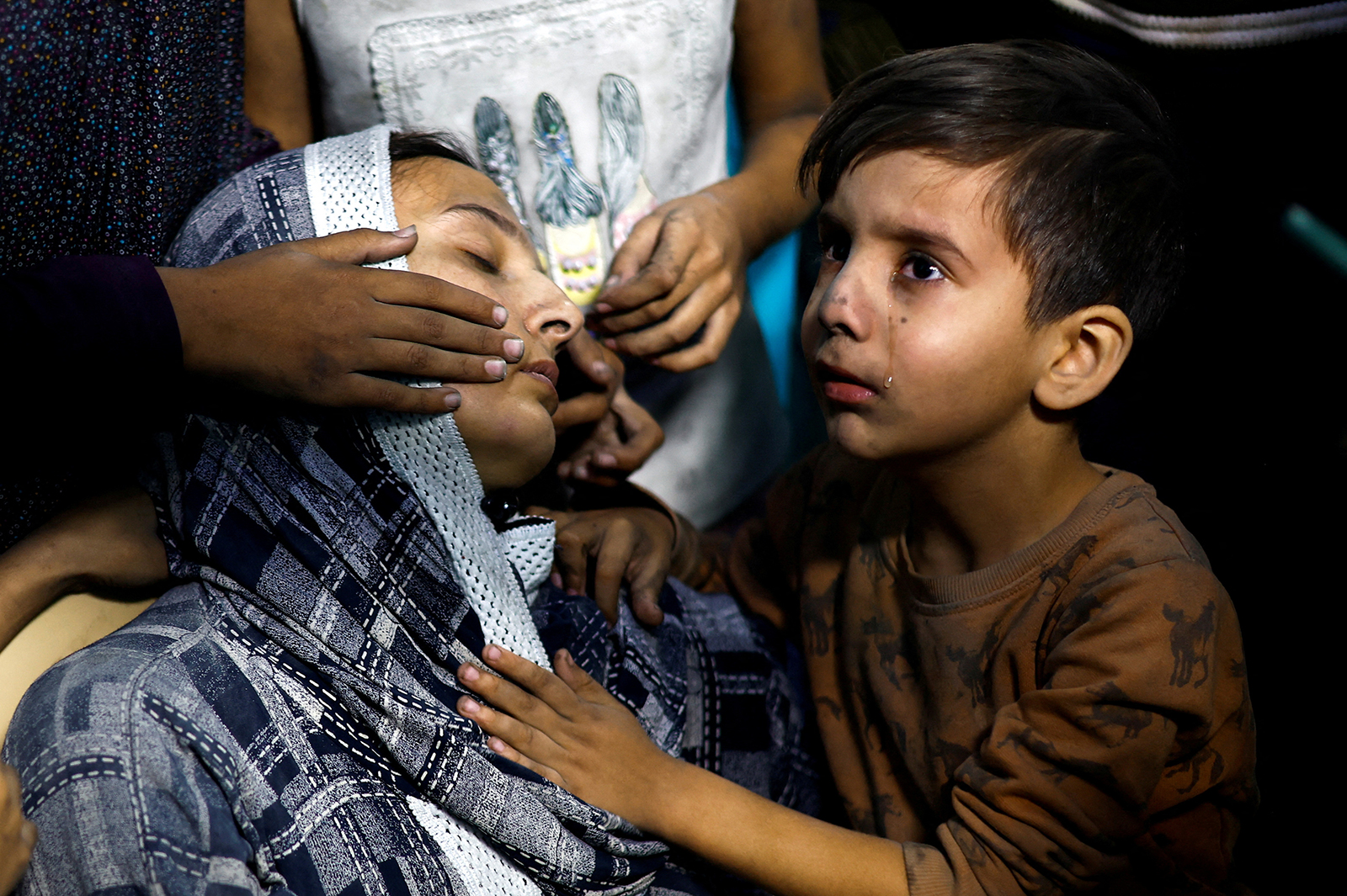 a-palestinian-child-cries-next-to-a-woman-after-israeli-strikes-at-a