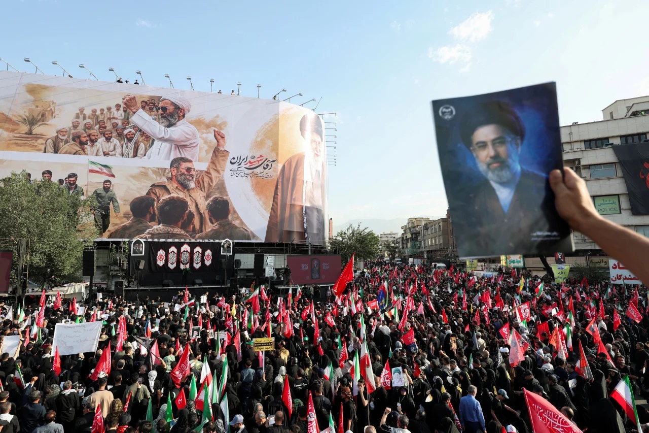 Mourners carry flags and chant as they throng Tehran streets for Khamenei funeral